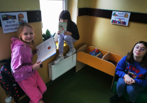 Uczennice z książkami w kąciku czytelnika.