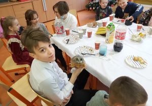 Chłopiec pokazuje figurkę żaby, którą otrzymał w prezencie.
